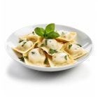 Assiette de raviolis frais Morini Pasta garnis d’herbes et basilic.