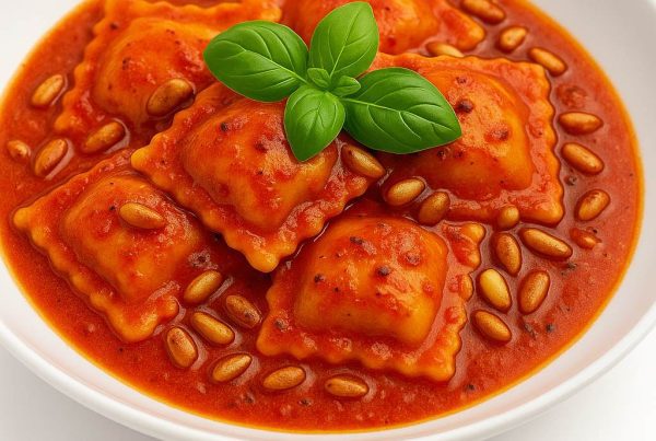 Plat de ravioli portugais nappés d’une sauce piri-piri légère avec pignons de pin grillés, présentation gourmet.